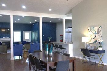 a living room filled with furniture and a wooden table